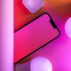 Colorful tech arrangement with smartphone and smart bulbs, perfect for modern design concepts.