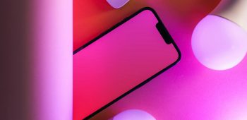Colorful tech arrangement with smartphone and smart bulbs, perfect for modern design concepts.